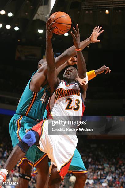 Jason Richardson of the Golden State Warriors jumps for the shot against Marc Jackson of the New Orleans/Oklahoma City Hornets on March 29, 2006 at...