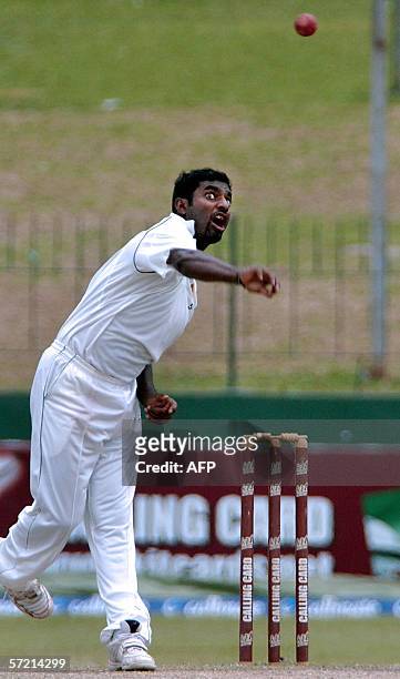Sri Lankan cricketer Muttiah Muralitharan delivers delivers the ball during the fifth day of the first Test match between Sri Lanka and Pakistan at...