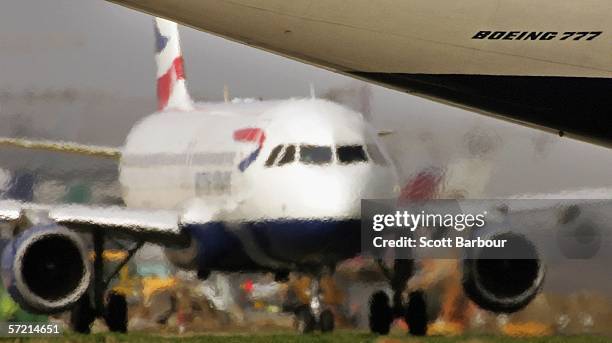 Exhaust emits from the engines of a Boeing 777 as another plane prepares for take off at Heathrow Airport on March 30, 2006 in London, England. Air...