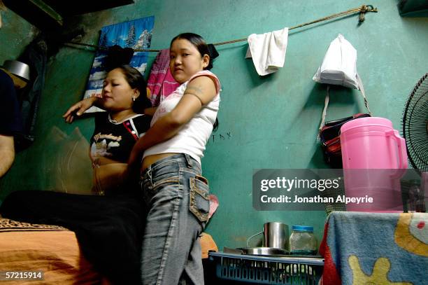 Puja Lama and her 17 year old cousin negotiate prices with a western client on November 14, 2005 in Siliguri, Utar Pradesh, India. They will ask for...