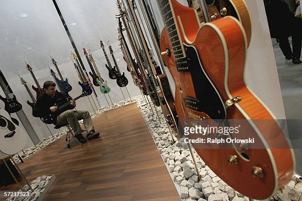 Visitor of the International Musikmesse plays a guitar at the Yamaha exhibition stand on March 30, 2006 in Frankfurt, Germany. At the 27th Frankfurt...
