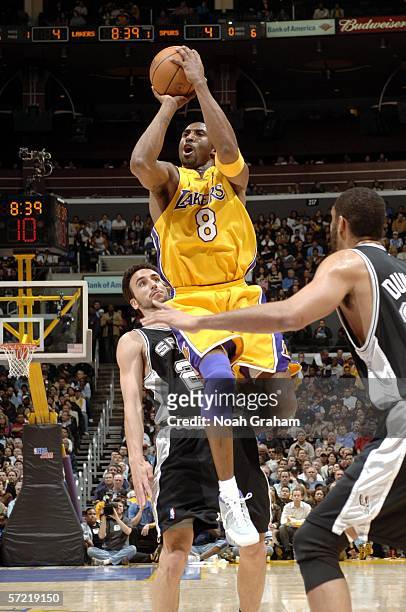 Kobe Bryant of the Los Angeles Lakers puts up a shot against Manu Ginobili and Tim Duncan of the San Antonio Spurs on March 30, 2006 at Staples...