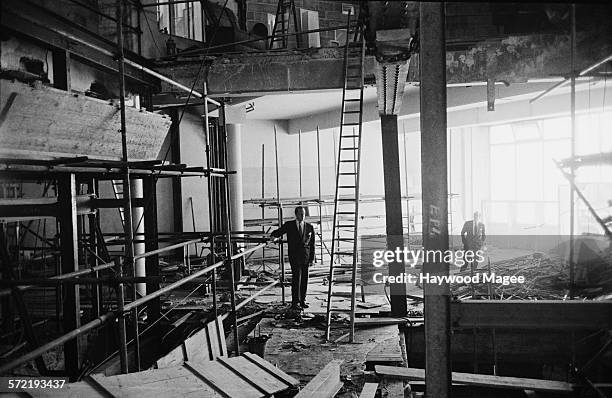 Associated-Rediffusion Controller of Programmes, Roland Gillett surveys the new studios under construction at Television House, on Kingsway, London,...