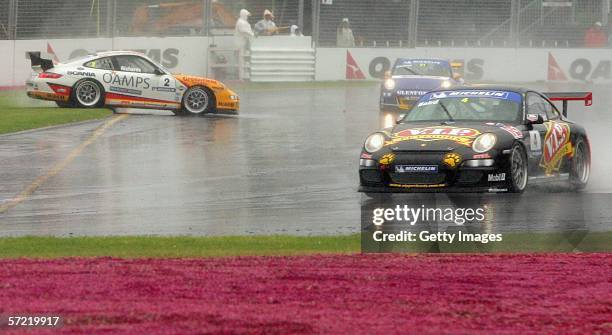 Craig Baird in action while Jim Richards spins during the Carrera Cup race during day two of the 2006 FORMULA 1 Foster's Australian Grand Prix at...