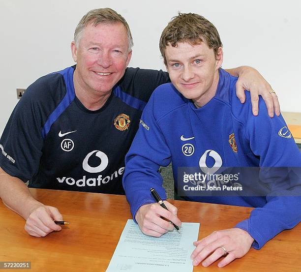 Ole Gunnar Solskjaer of Manchester United poses with Sir Alex Ferguson after signing a new contract at Carrington Training Ground on March 31, 2006...