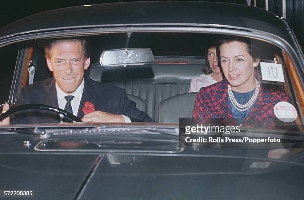 George Lascelles, 7th Earl of Harewood pictured at the wheel of his Jaguar car with his new wife, Australian model Patricia 'Bambi' Tuckwell, as they...