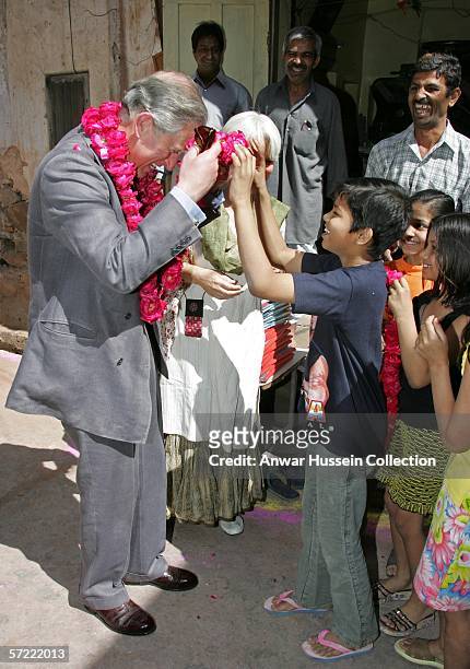 Prince Charles, Prince of Wales receives a garland as he takes a walking tour of the Old City on the final day of a 12 day official tour visiting...