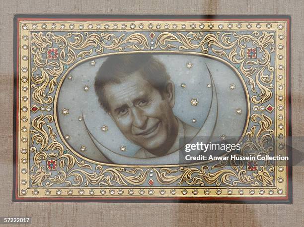 Prince Charles, Prince of Wales receives a picture of himself as he takes a walking tour of the Old City on the final day of a 12 day official tour...