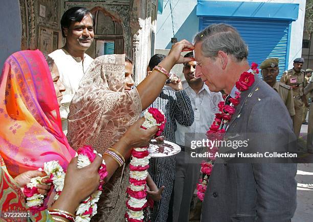 Prince Charles, Prince of Wales receives a tilak mark on his forehead as he takes a walking tour of the Old City on the final day of a 12 day...