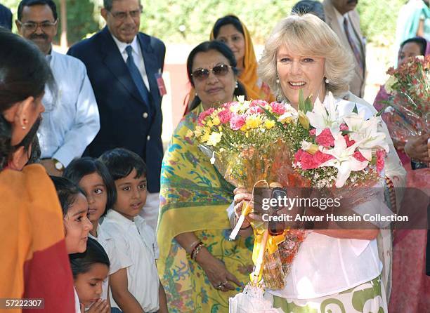 Camilla, Duchess of Cornwall receives a bouquet of flowers at the Montessori Palace School in Jaipur on the final day of a 12 day official tour...