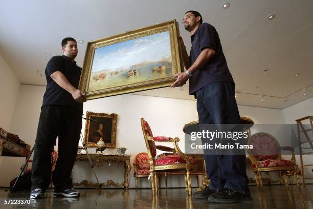 Art handlers Alvaro Fonseca and David Hernandez hold Turner's Venetian masterpiece "Giudecca, La Donna della Salute and San Giorgio" at a press...