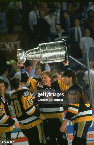 Canadian professional hockey player Troy Loney , forward for the Pittsburgh Penguins, hoists the Stanley Cup over his head as he celebrates his...