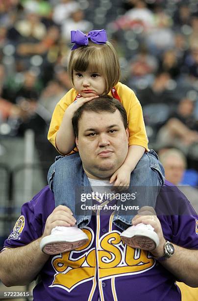 Brett and daughter Shannon Smith from Shreveport, Louisiana watch the Louisiana State Tigers practice the day before the Final Four on March 31, 2006...