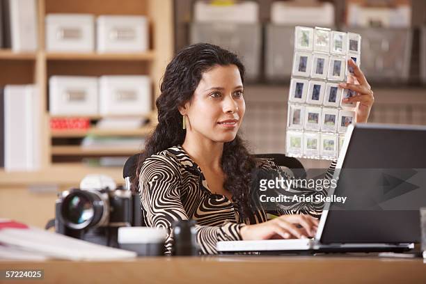 woman looking at slides - diams stock-fotos und bilder