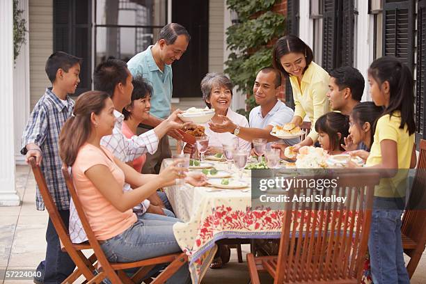 family eating outside - big family dinner stock pictures, royalty-free photos & images