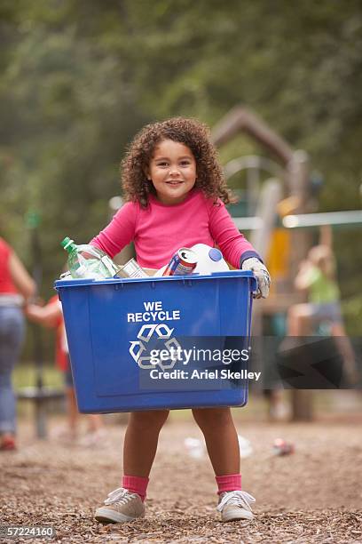 girl carrying recycling container - mixed recycling bin stock pictures, royalty-free photos & images