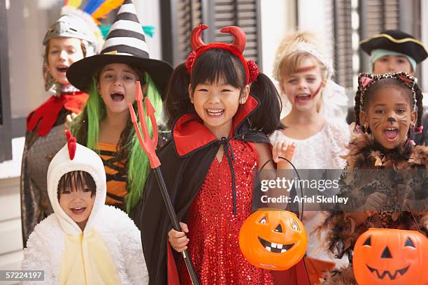 group of children dressed up in costumes for halloween - halloween kids fotografías e imágenes de stock