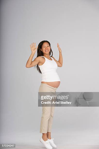 portrait of pregnant woman jumping - pregnant isolated stock pictures, royalty-free photos & images