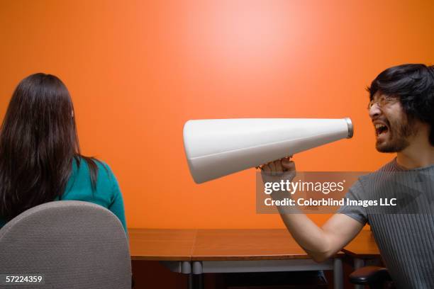man with megaphone yelling at woman - asian loud hailer stock pictures, royalty-free photos & images
