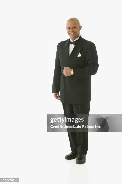 full view portrait of man in tuxedo - smoking activity stock-fotos und bilder