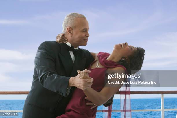 formal couple dancing on cruise ship - imbarcazione per passeggeri foto e immagini stock