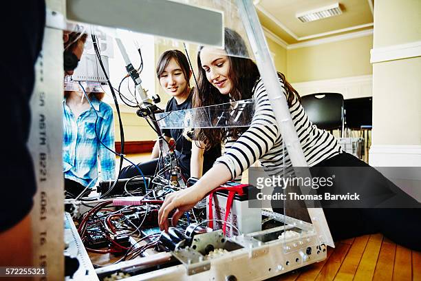 female robotics team working on wiring of robot - public scrutiny stock pictures, royalty-free photos & images