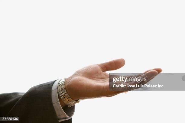 close up of businessman's hand extended palm up - black suit close up stock pictures, royalty-free photos & images