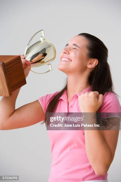 portrait of excited teenage girl with trophy - teen awards bildbanksfoton och bilder