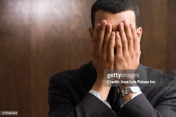 businessman with hands over face - pessimism stock pictures, royalty-free photos & images