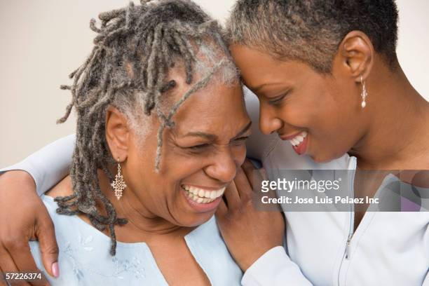 grown daughter hugging mother - incoraggiamento foto e immagini stock
