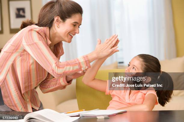 mother giving daughter high five - congratulating child stock pictures, royalty-free photos & images