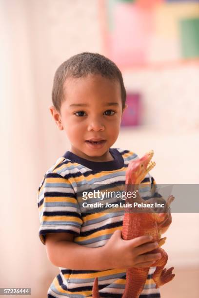 portrait of young boy with toy dinosaur - dinosaur toy i stock pictures, royalty-free photos & images