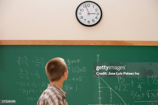 student watching the clock in class - clock on wall stock pictures, royalty-free photos & images