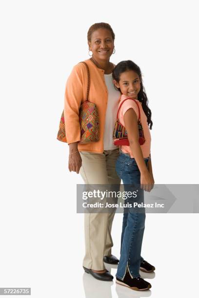 mother and daughter posing for the camera with purses - enkel object stock-fotos und bilder