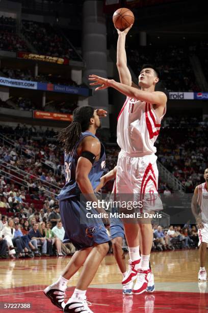 Yao Ming of the Houston Rockets shoots over Etan Thomas of the Washington Wizards on March 31, 2006 at the Toyota Center in Houston, Texas. NOTE TO...