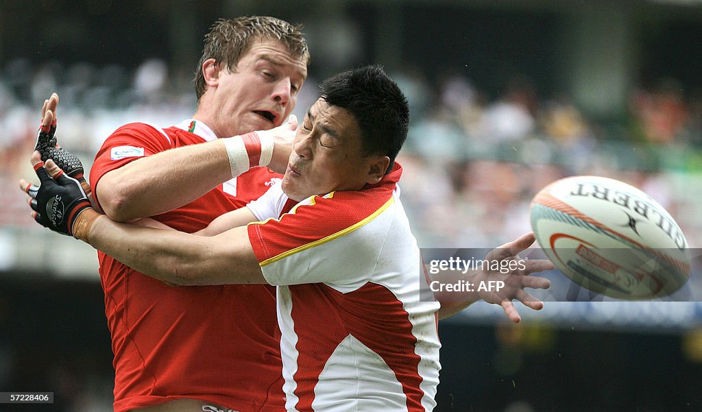 Rhys Oakley of Wales (L) vies with Yuan