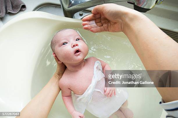 mothers pov of bathing her baby - virtualitytrend stock-fotos und bilder
