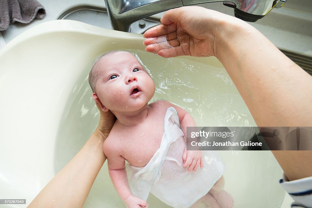 Mothers POV of bathing her baby