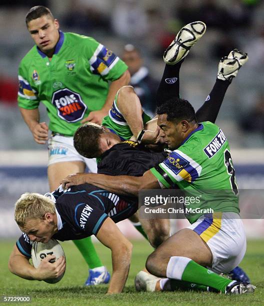 Luke Lewis of the Panthers is up ended by the Raiders defence during the round four NRL match between the Canberra Raiders and the Penrith Panthers...