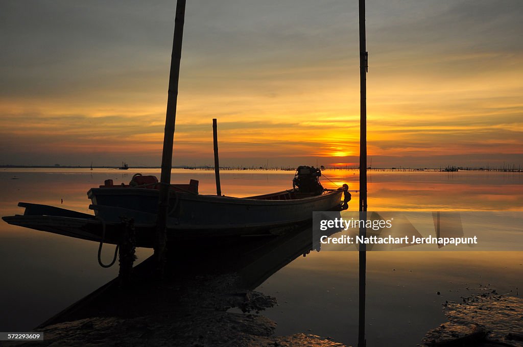 Fisherman boat on the amazing sunset time