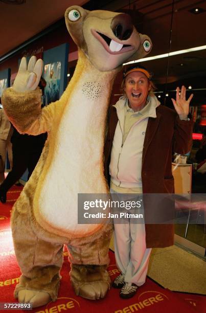 Otto Waalkes stands next to the cartoon character "SID" as he attends the German premiere of the movie Ice Age 2 on April 1, 2006 in Munich, Germany....