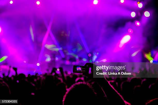 fan taking cell phone photograph of music stage - concert crowd mobile phones stock-fotos und bilder
