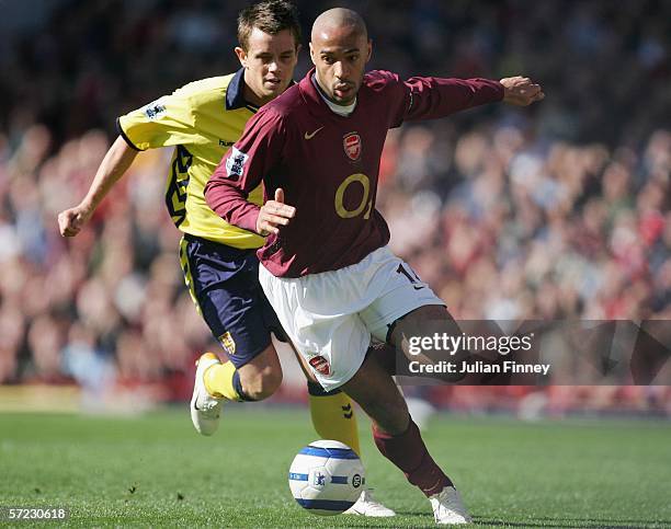 Thierry Henry of Arsenal and Lee Hendrie of Aston Villa in action during the Barclays Premiership match between Arsenal and Aston Villa at Highbury...