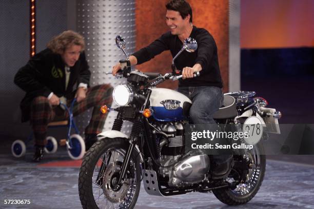 Actor Tom Cruise rides a motorcycle after losing a bet at the talk and game show "Wetten Dass . . . ?" April 1, 2006 in Halle, Germany.