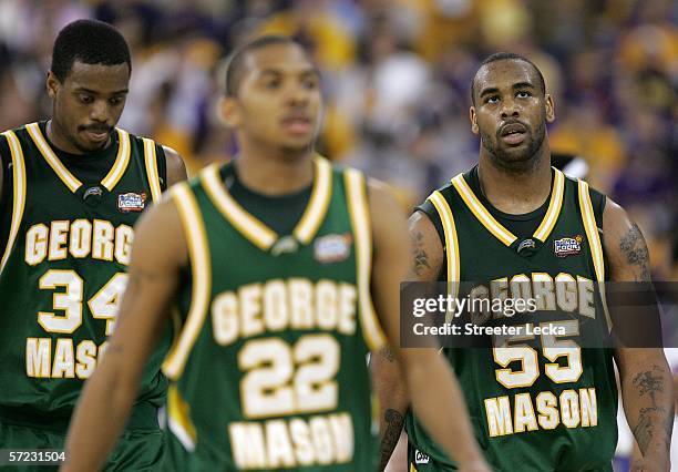 Will Thomas, Lamar Butler and Jai Lewis of the George Mason Patriots walk towards the bench in the second half against the Florida Gators during the...