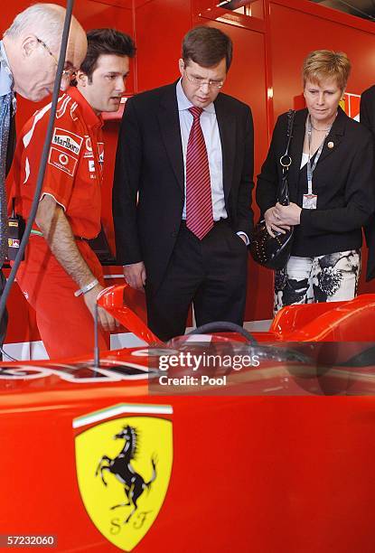 Dutch Prime Minister Jan Peter Balkenende and and Dutch Minister for Trade Ross van Dorp inspect Michael Schumacher's car with Ferrari's sponsorship...