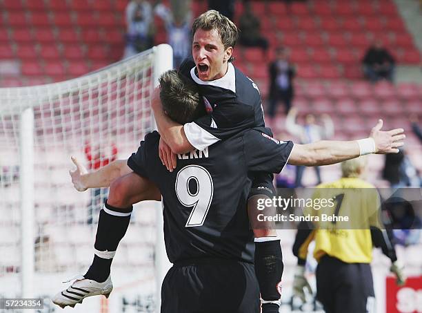 Enrico Kern of Rostock celebrates scoring the first goal with his team mate Tobias Rathgeb during the Second Bundesliga match between Spvgg...