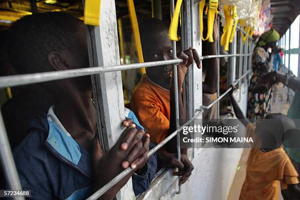 Young Sudanese girl bids farewell to some of the 400 southern Sudanese aboard an International Organization for Migration barge on river nile in Juba...