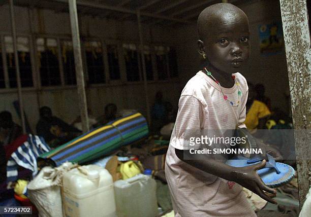 Girl, one of some of the 400 southern Sudanese aboard an International Organization for Migration barge on river nile in Juba returns home to the...