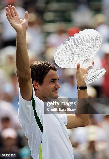 Roger Federer of Switzerland waves to the crowd as he holds up his trophy after winning the men's final by defeating Ivan Ljubicic of Croatia during...